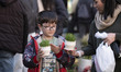 An Iranian family looks at green sprouts, a key symbol of the Iranian New Year, during New...