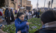 People shop for green sprouts, a key symbol of the Iranian New Year, during New Year shopp...