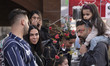 A family looks at flowers during New Year shopping in northern Tehran, Iran, on March 18,...