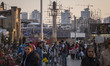 People shop for New Year decorations from a street vendor outside a holy shrine during New...