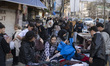 People shop from street vendors during New Year shopping in northern Tehran, Iran, on Marc...