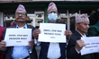 Activists from the Human Rights and Peace Society hold placards during a protest calling f...