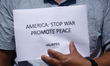 Activists from the Human Rights and Peace Society hold placards during a protest calling f...