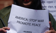 Activists from the Human Rights and Peace Society hold placards during a protest calling f...