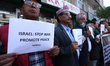 Activists from the Human Rights and Peace Society hold placards during a protest calling f...