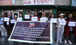 Activists from the Human Rights and Peace Society hold placards during a protest calling f...