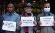 Activists from the Human Rights and Peace Society hold placards during a protest calling f...