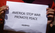 Activists from the Human Rights and Peace Society hold placards during a protest calling f...