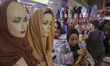 People shop for clothes ahead of Eid al-Fitr celebrations at Tanah Abang Market in Jakarta...