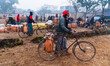 People arrive by bicycle to sell wild date sap in the market on January 22, 2026. 