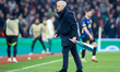 Lille OSC's manager, Bruno Genesio, retrieves a dart fashioned from a pennant from the pit...