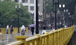 Pedestrians navigate a storm in Sao Paulo, Brazil, on March 19, 2026. 