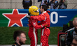 Scuderia Ferrari HP driver #44 Lewis Hamilton from Great Britain embraces a team member in...