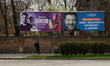 An elections banner is seen with an image depicting Ukrainian President Volodymyr Zelensky...