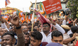 Supporters of the Bharatiya Janata Party (BJP) gather and wave party flags during the nomi...