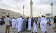 People gather after Eid al-Fitr prayers on the first day of the Eid al-Fitr holiday in Doh...