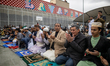 People celebrate Eid al-Fitr, marking the end of Ramadan, in the Lavapies neighborhood of...