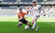 MK Dons' Ben Wiles is challenged by Barnet's Nikola Tavares during the second half of the...