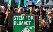 A protester holds up a placard that reads 'Vote for the climate' during Folkets Klimamarch...