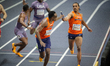 Eugene Omalla passes the baton to Liemarvin Bonevacia of Team Netherlands during heat 1 of...