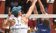 Nicolas Capogrosso of Argentina spikes the ball against Logan Webber of the United States...