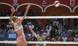 Monika Paulikiene of Lithuania spikes the ball against Anna Pavelkova of the Czech Republi...