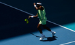 Frances Tiafoe of the United States returns a shot against Jannik Sinner of Italy during t...