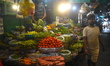 A vendor sells vegetables inside a market in Kolkata, India, on March 29, 2026. 