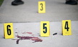 Members of the NYPD Crime Scene Unit collect a knife, shell casings, and swab blood at the...
