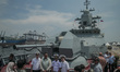 Visitors take photos aboard the Gromky-335 corvette while it is docked at Tanjung Priok Po...