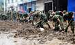 Soldiers clean up streets in Jingxing County, north China's Hebei Province, July 29, 2016....