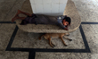A street child is sleeping in a railway station, Kamlapur, Dhaka, on August 7, 2016. 