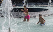 Children cool off in fontain in Paris on a hot day on August 25, 2016. 