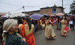 An old woman watch the dance as Hindu devotees lining to offer ritual prayer at the Rishis...