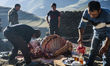 Men butcher a bull in a yard in Khinalig village, Quba region, Azerbaijan. Khinalig is an...