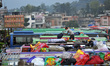 A Bus sub driver arranging travelers Bag and luggage's on the roof of Bus for travel to th...