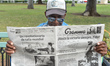 Ornando (age 77) reads 'Granma' - the official voice of the PCC, near El Capitolio (Nation...