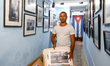 William, a local photographer shows his work inside his small shop/gallery, in Havana's ce...