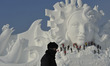 Chinese workers carve a large snow sculpture "Love Song" for the 29th Harbin Sun Island In...