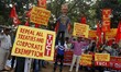 Activists of the Trade Union Centre of India hold placards and shouted anti government slo...