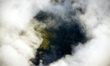 A view of the cliffs amid clouds of the 'Enclos Fouqué' caldera where the 'Piton de la Fou...