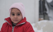 A refugee chid poses in northern Greece in camps in or around Thessaloniki city on 11 Janu...