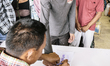 Migrant Cambodian workers register their names and leave their fingerprints with Thai mili...