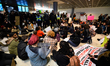 Black Lives Matter protestors hold a sit in and block an exit as thousands turn out for a...