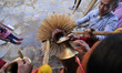 Nepalese devotee filling water on a pot carries by a Nepalese people impersonate as Hindu...