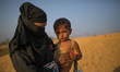 A Rohingya refugee mother is holding her child in Kutupalong Refugee camp, Cox's Bazar, Ba...