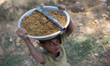 A Rohingya refugee girl carries mud in a bowl in Kutupalong Refugee Camp, Cox's Bazar, Ban...