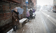 People are seen in the streets of Bydgoszcz, Poland during heavy snowfall on 24 February,...