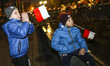 Young boys hold Polish flags during the visit of the President of Poland, Andrzej Duda in...