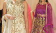 Indian fashion models wearing elegant and ornate bridal outfits during a South Asian brida...